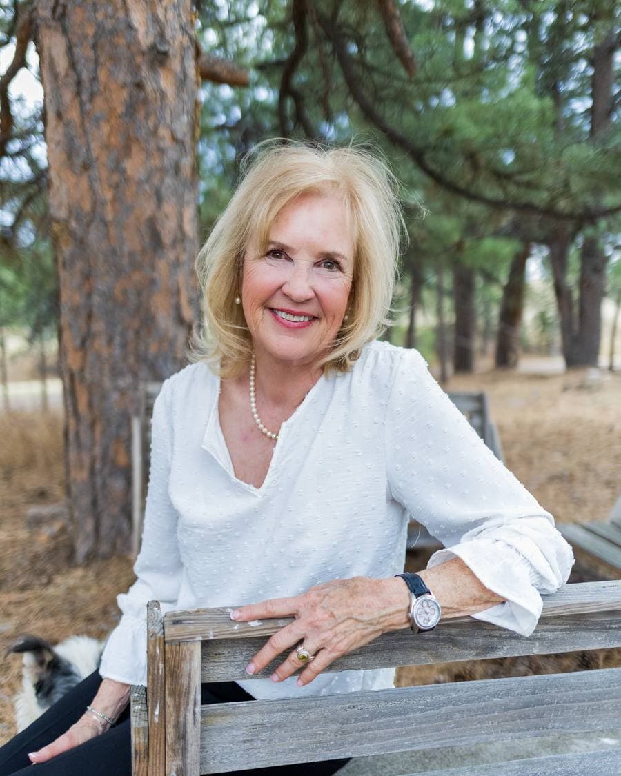 Belinda Seville outdoors in a dark jacket, open Colorado country behind her.